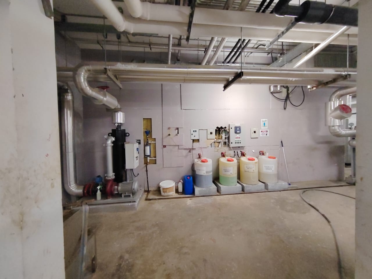 Wide view of a service area showing equipment, floor space and access route